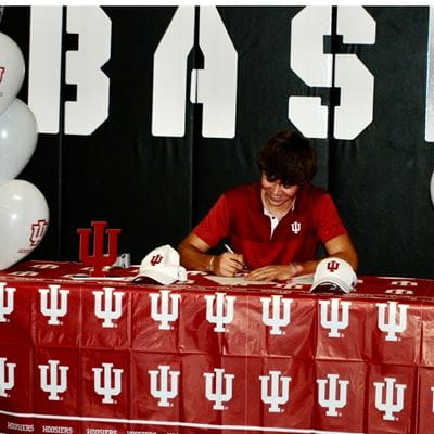 Andrew Meier signs his commitment to Indiana University Men's tennis.