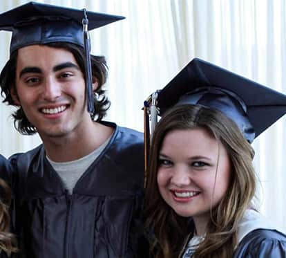 Three young adults celebrating their graduation ceremony