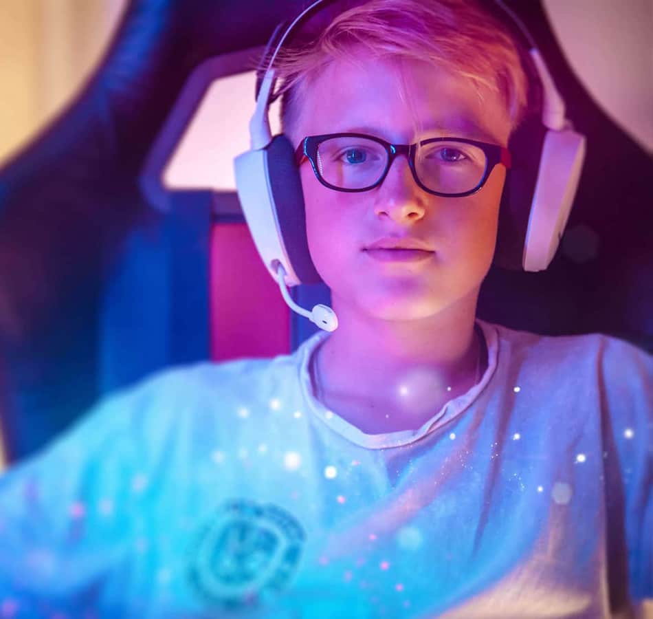Young boy gamer in headset near computer
